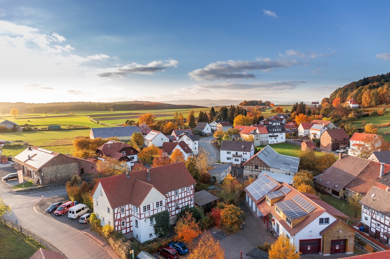 The Art of Drawing Readers In: Your attractive post title goes here Charming aerial view of a rural village in autumn with vivid colors and clear skies.